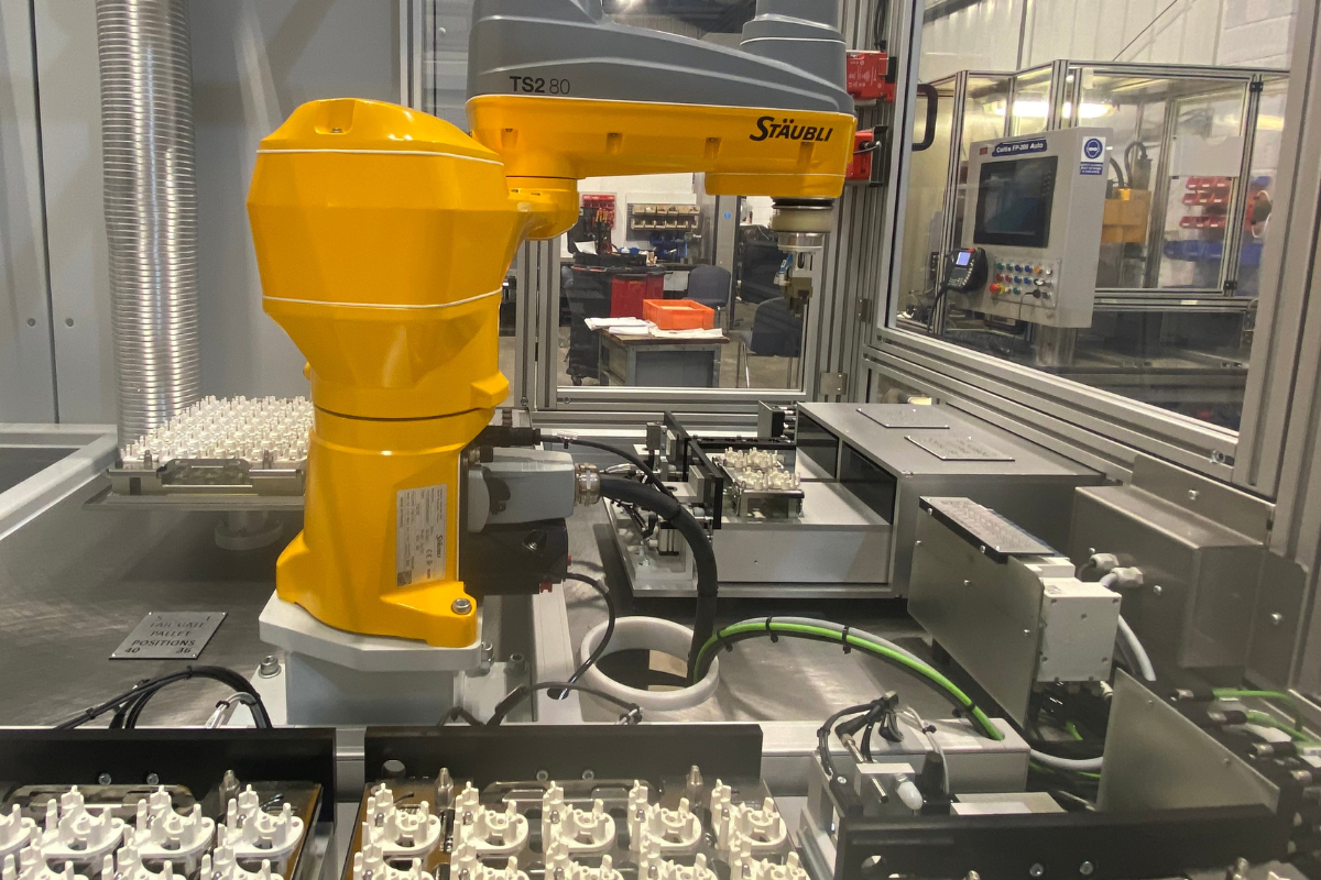 Robotic assembly cell integrated by Curtis Assemble & Test featuring industrial robot and automated fixturing