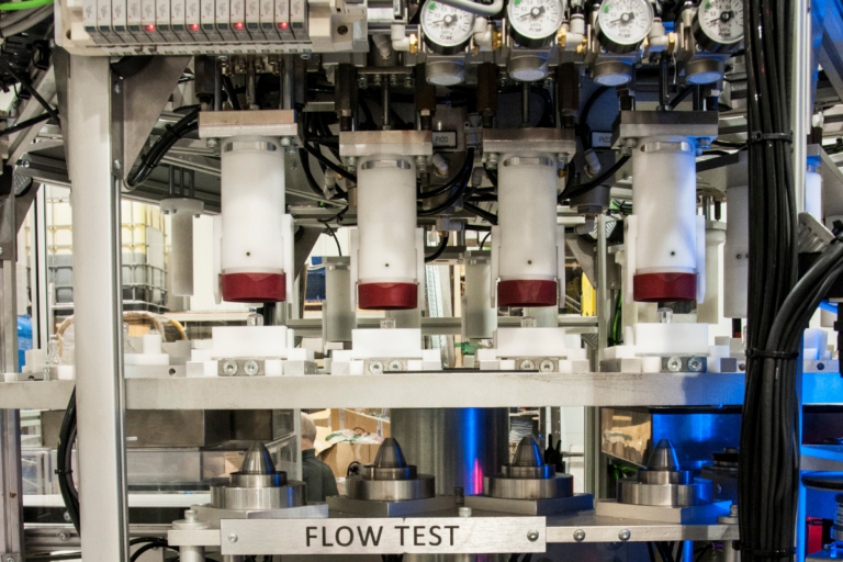 Flow-based fluid and air leak detection test rig